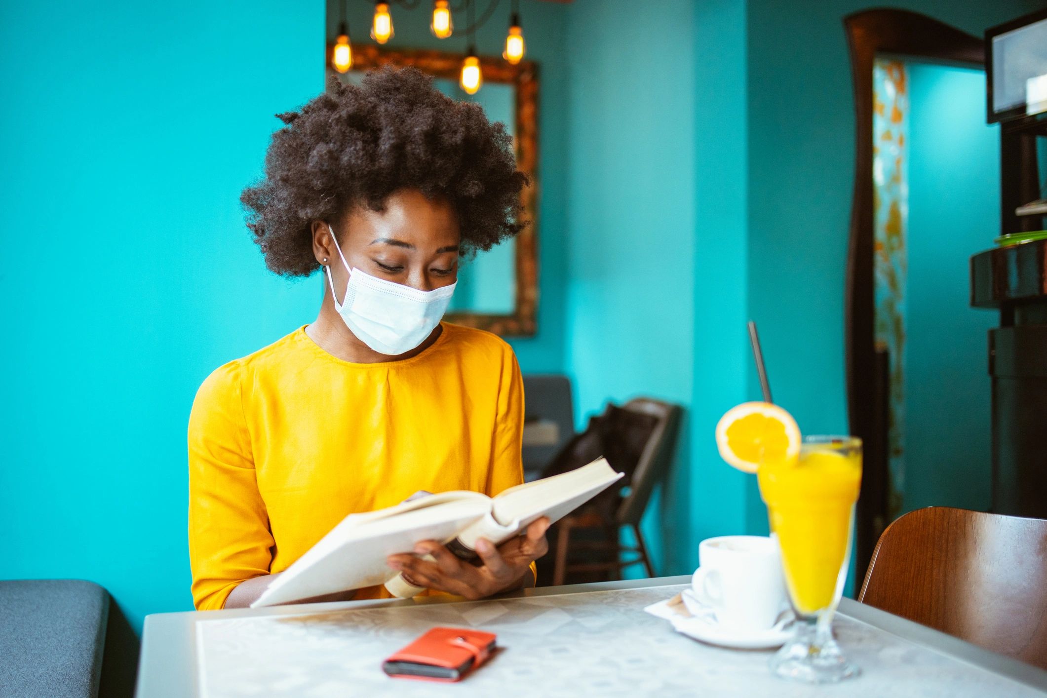 Woman enjoying a quiet reading moment with a book and coffee