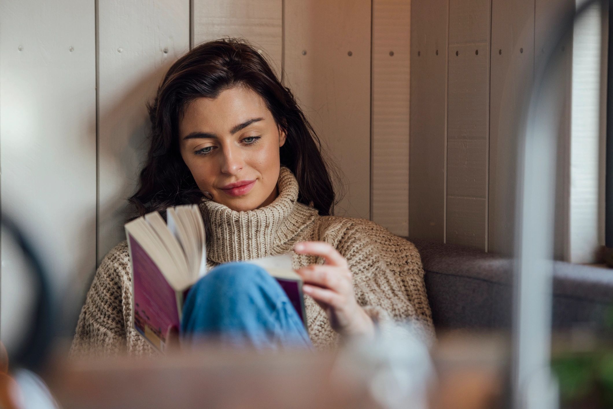 Woman reading comfortably in a peaceful setting