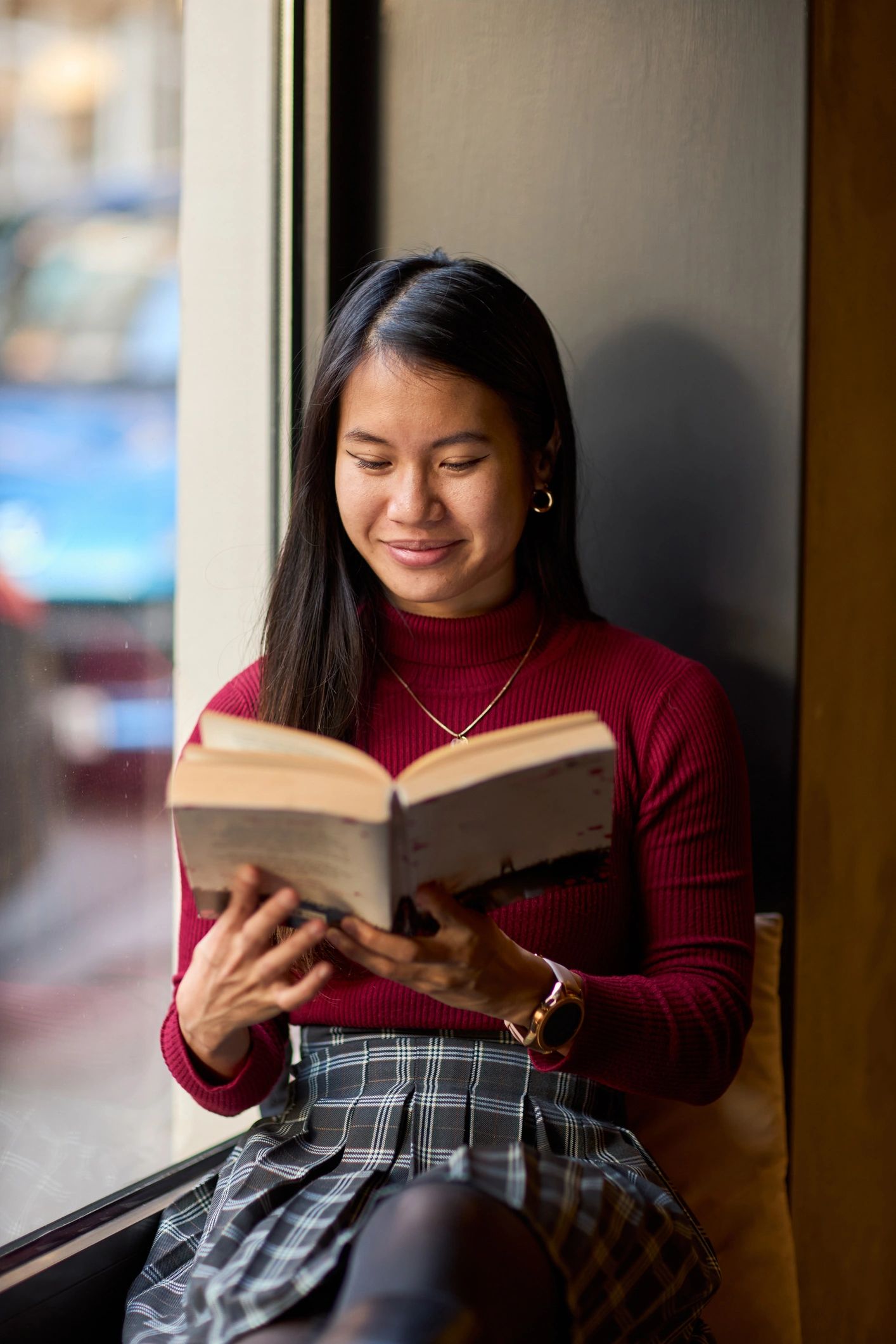 Woman reading in a cozy bookstore setting