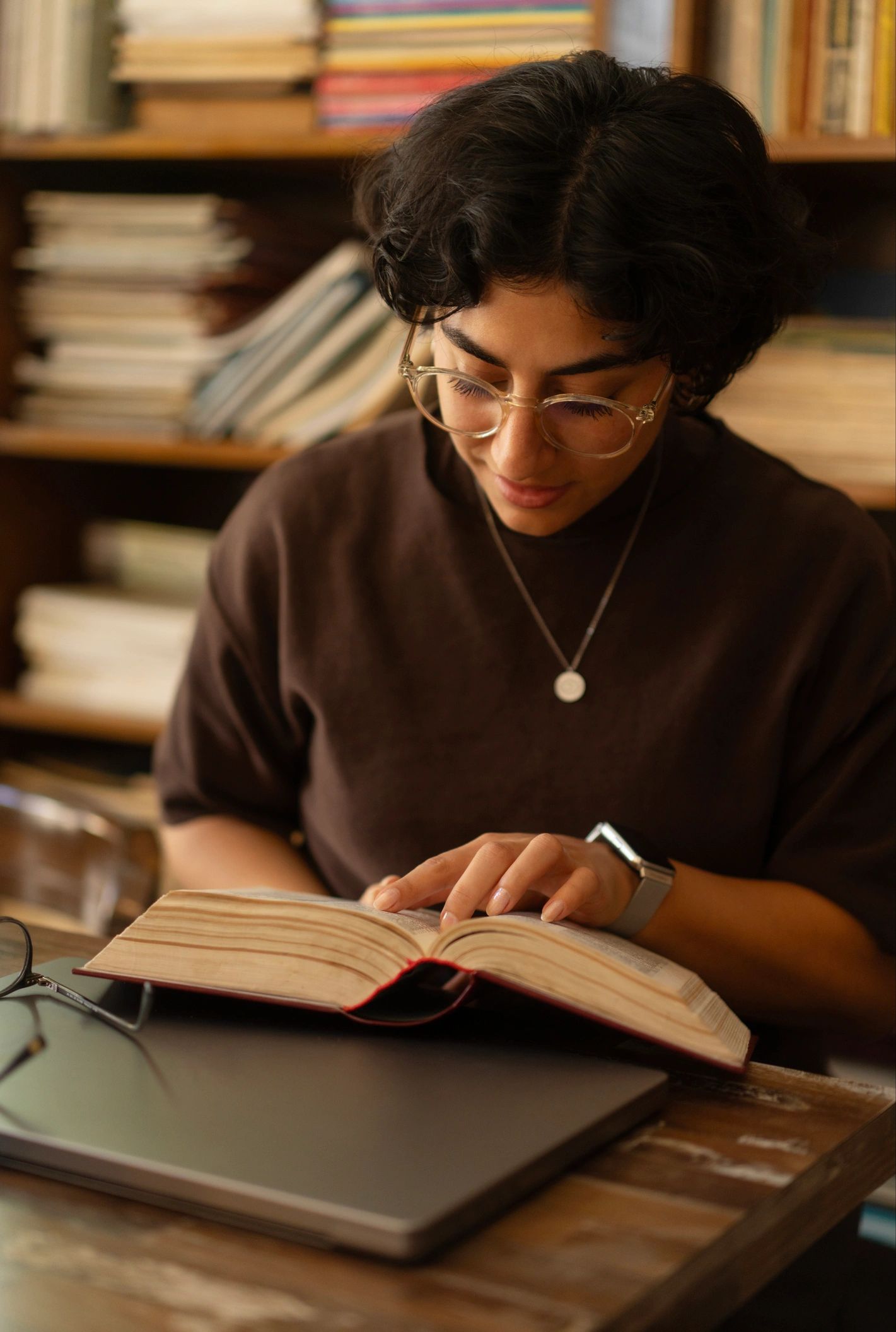 Bookseller reading in a cozy library setting